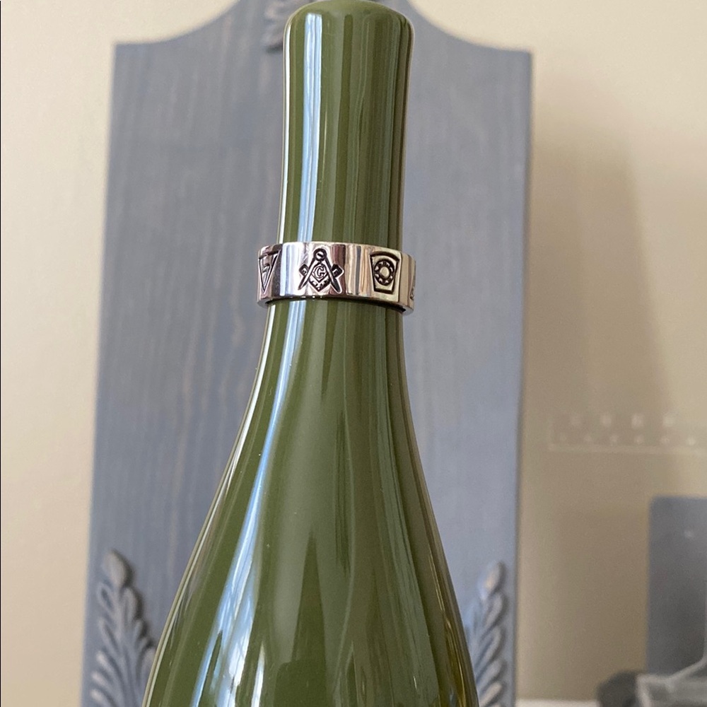 Silver tone Masonic ring features seven symbols. Measures approximately 12 1/2.